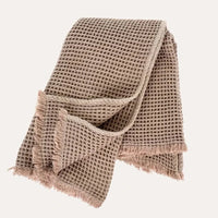 Indaba waffle throw in soft blush pink with thick textured waffle weave and fringe — Lemonberry Aurora