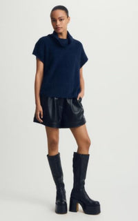 Model wearing Jack Sweater in navy with leather shorts and boots, shot at Lemonberry.