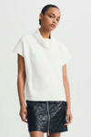 White Jack Sweater styled with a quilted zip-up mini skirt, cropped shot.