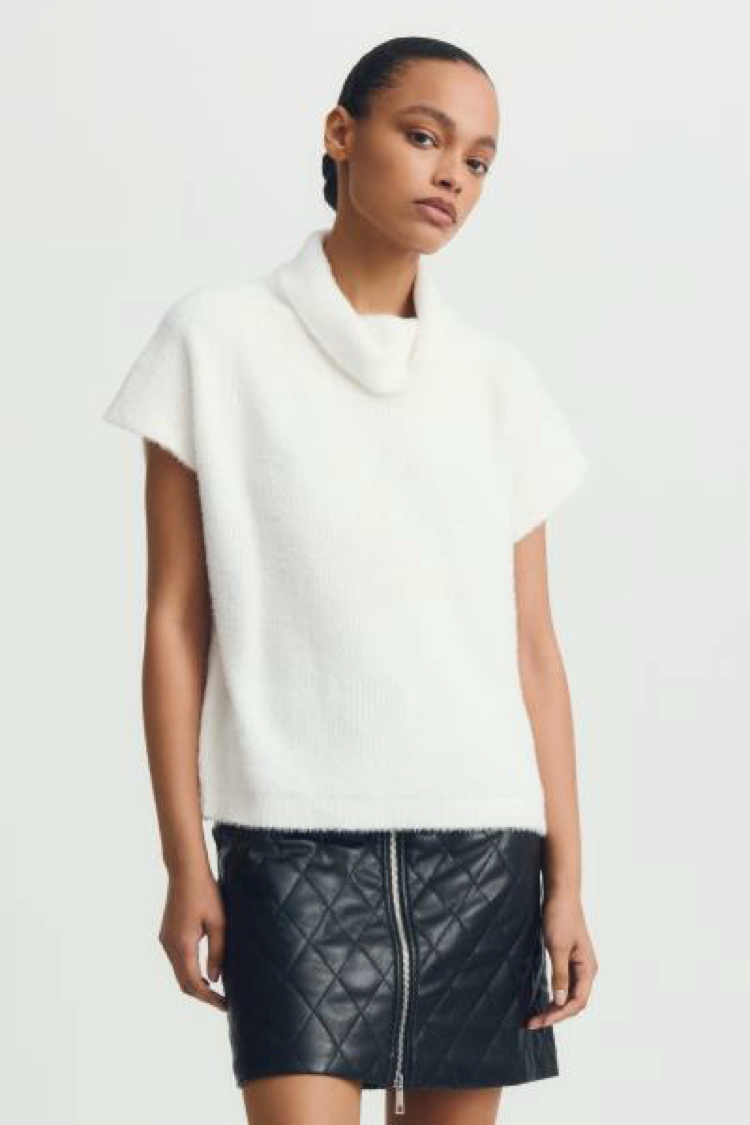 White Jack Sweater styled with a quilted zip-up mini skirt, cropped shot.