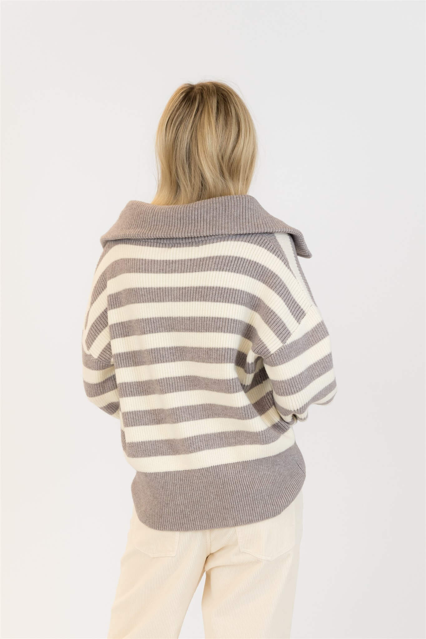Back view of Lyla & Luxe James Sweater showing striped knit pattern