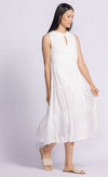 Model gently lifting the fabric of the Jennifer Dress by Pink Martini, highlighting its lightweight, flowy rayon material.