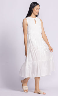Model gently lifting the fabric of the Jennifer Dress by Pink Martini, highlighting its lightweight, flowy rayon material.