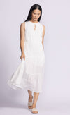 Model wearing the Jennifer Dress by Pink Martini, a tiered flowy midi dress with an elastic waistband, standing in a relaxed pose.
