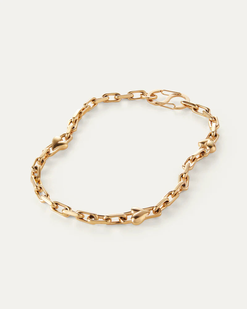 Jenny Bird Art Heart Chain Necklace in high-polish gold, flat lay on neutral background