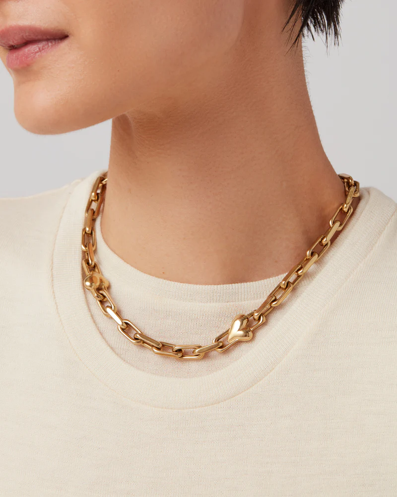 Model wearing Jenny Bird Art Heart Chain Necklace in high-polish gold with crewneck top