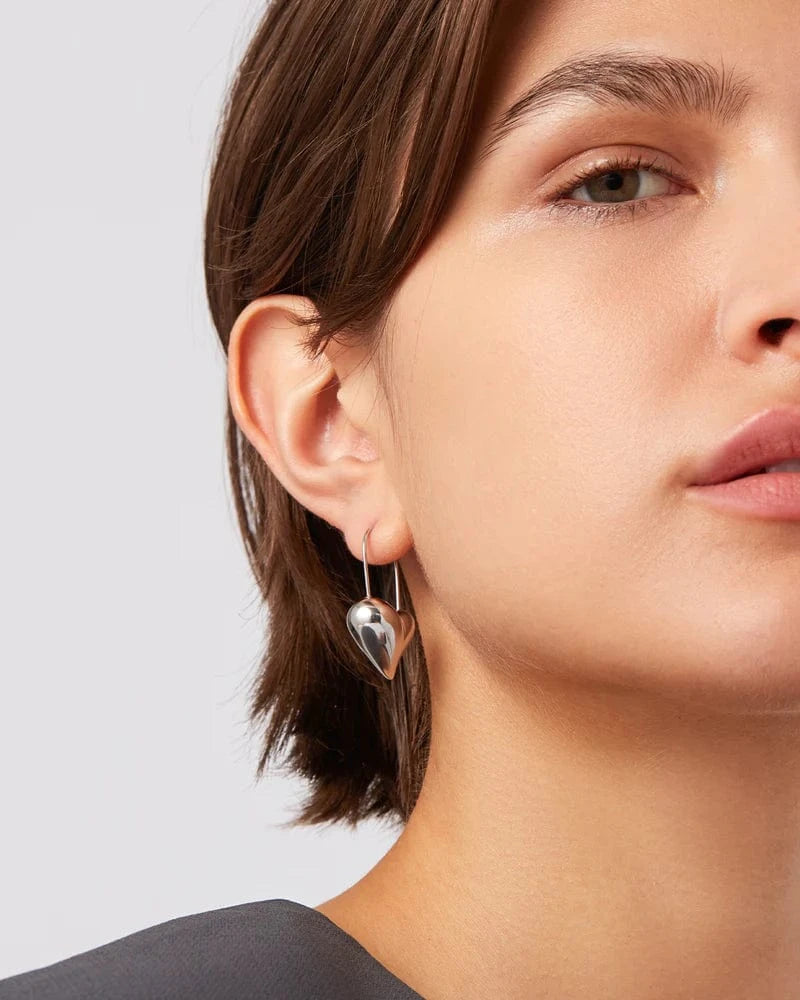 Silver Heart Earrings styled on model in charcoal top, Lemonberry Aurora.