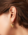 Worn on model ear, Lemonberry Aurora.
