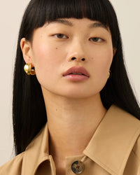 Jenny Bird Chunky Doune Hoop Earrings in 14K gold plated brass on a model  — Lemonberry Aurora close-up
