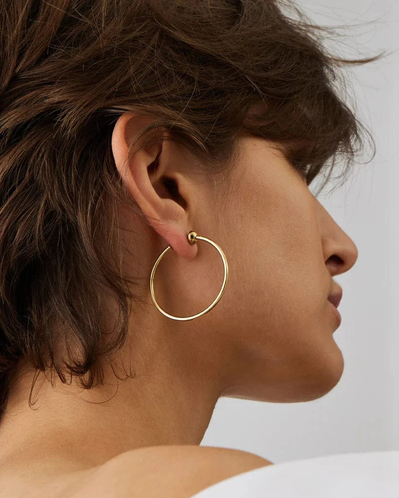 Jenny Bird Icon Hoops Small in gold — worn on model ear, Lemonberry Aurora — polished everyday hoop earrings.
