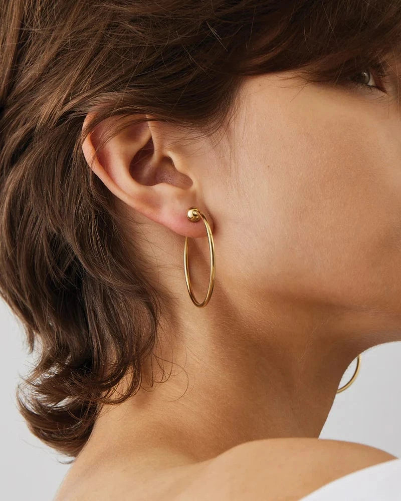 Jenny Bird Icon Hoops Small in gold — closeup worn on model ear, Lemonberry Aurora — polished everyday hoop earrings.