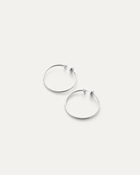 Pair of silver hoop earrings on a white background
