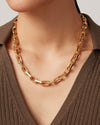 Jenny Bird Loire Necklace in gold, worn by a person against a neutral background