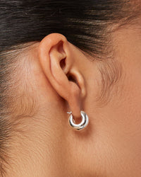 Close-up of Jenny Bird Mini Tome silver earrings worn on ear, Lemonberry Boutique Aurora