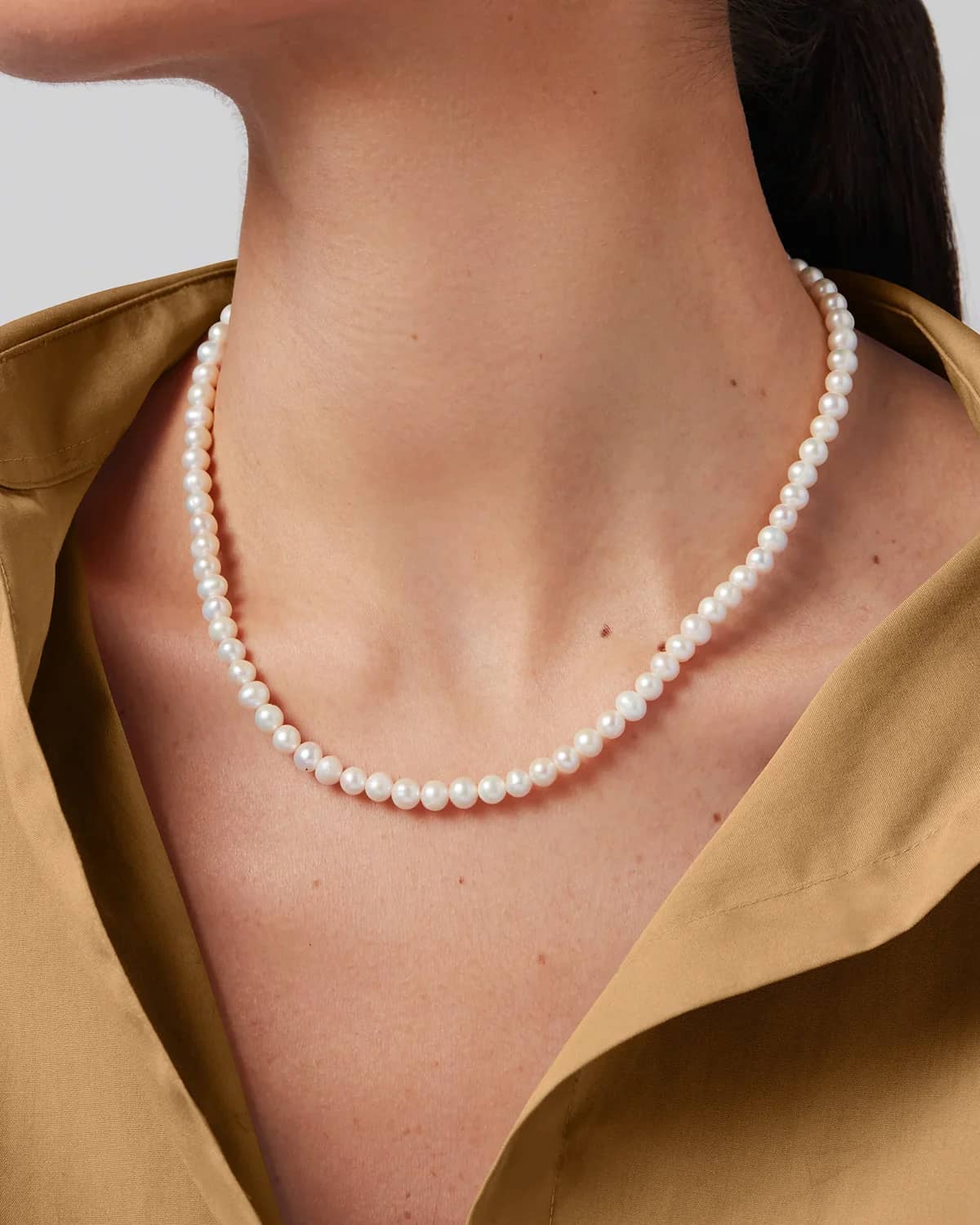 Jenny Bird Noa necklace freshwater pearl strand worn on model neck Lemonberry Aurora