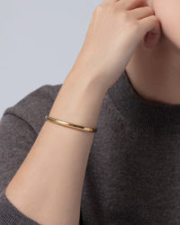 Jenny Bird Remi gold bangle front view on model Lemonberry Aurora