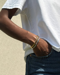 Jenny Bird Remi bangle worn in a mixed-metal bracelet stack Lemonberry Aurora