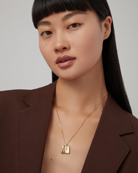 Jenny Bird Sundra Small Pendant Necklace in gold — worn on model neckline, Lemonberry Aurora.