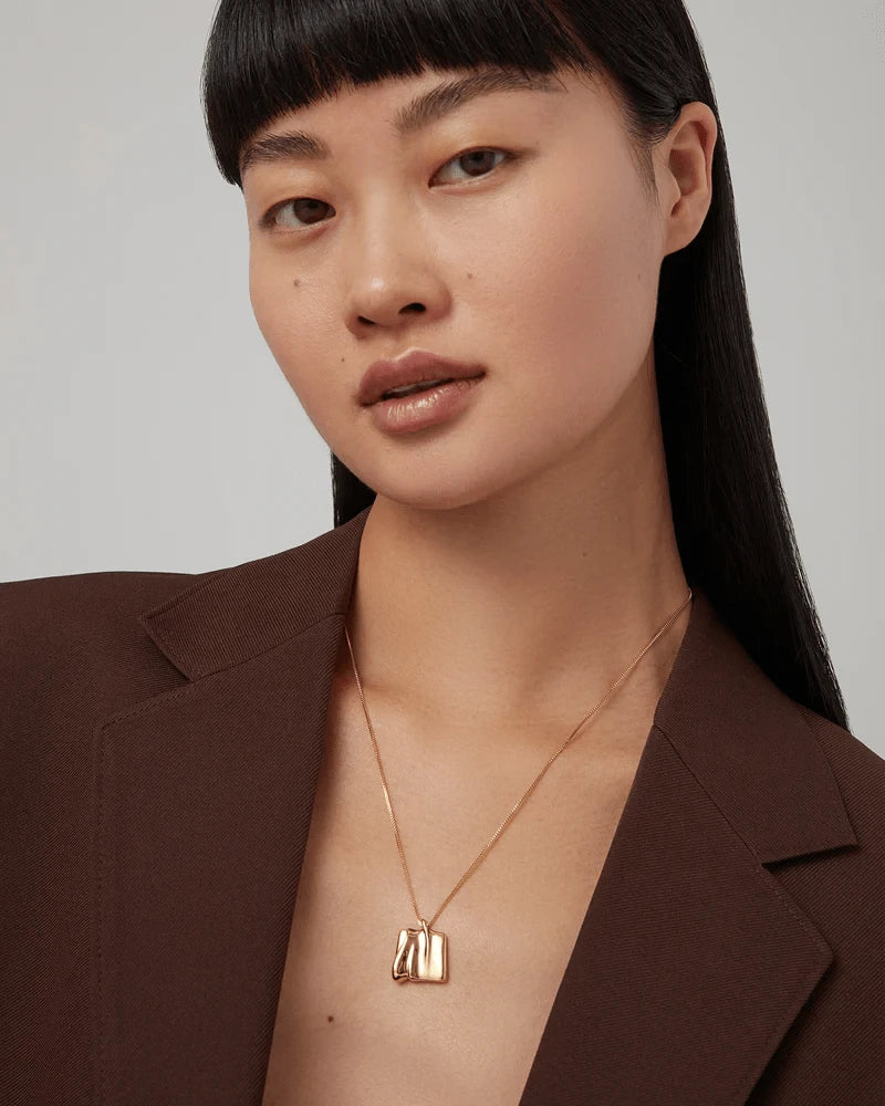 Jenny Bird Sundra Small Pendant Necklace in gold — worn on model neckline, Lemonberry Aurora.