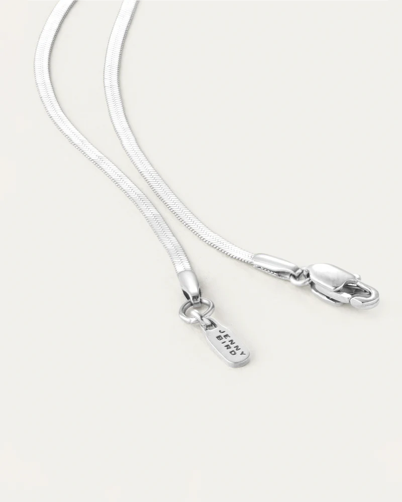 Close-up of Jenny Bird Zeina Slim Chain silver herringbone necklace clasp and chain detail