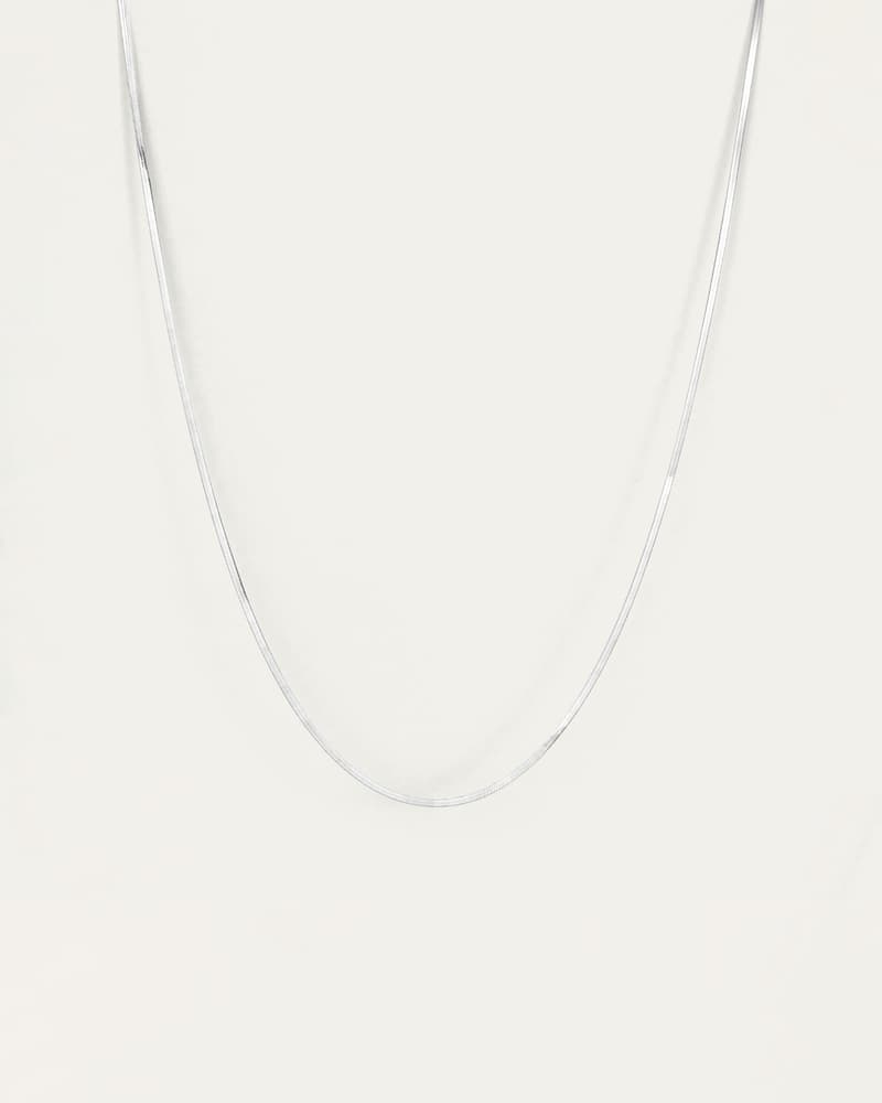 Jenny Bird Zeina Slim Chain silver herringbone necklace shown flat on a light background
