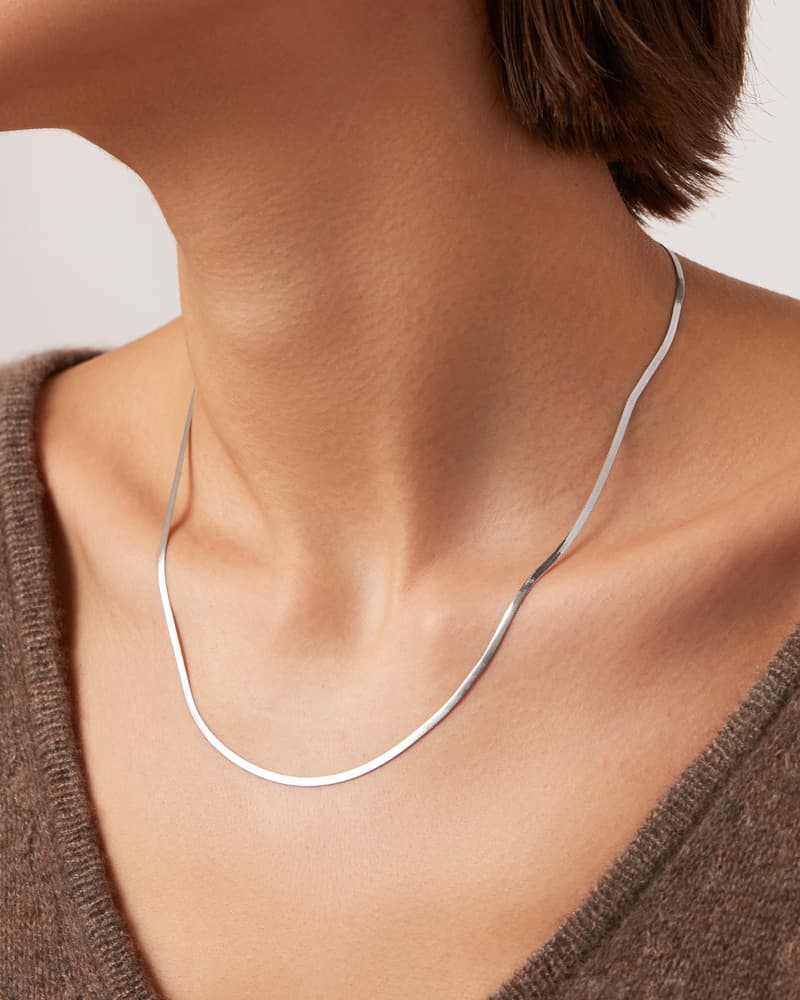 Jenny Bird Zeina Slim Chain silver necklace sitting flat against the collarbone