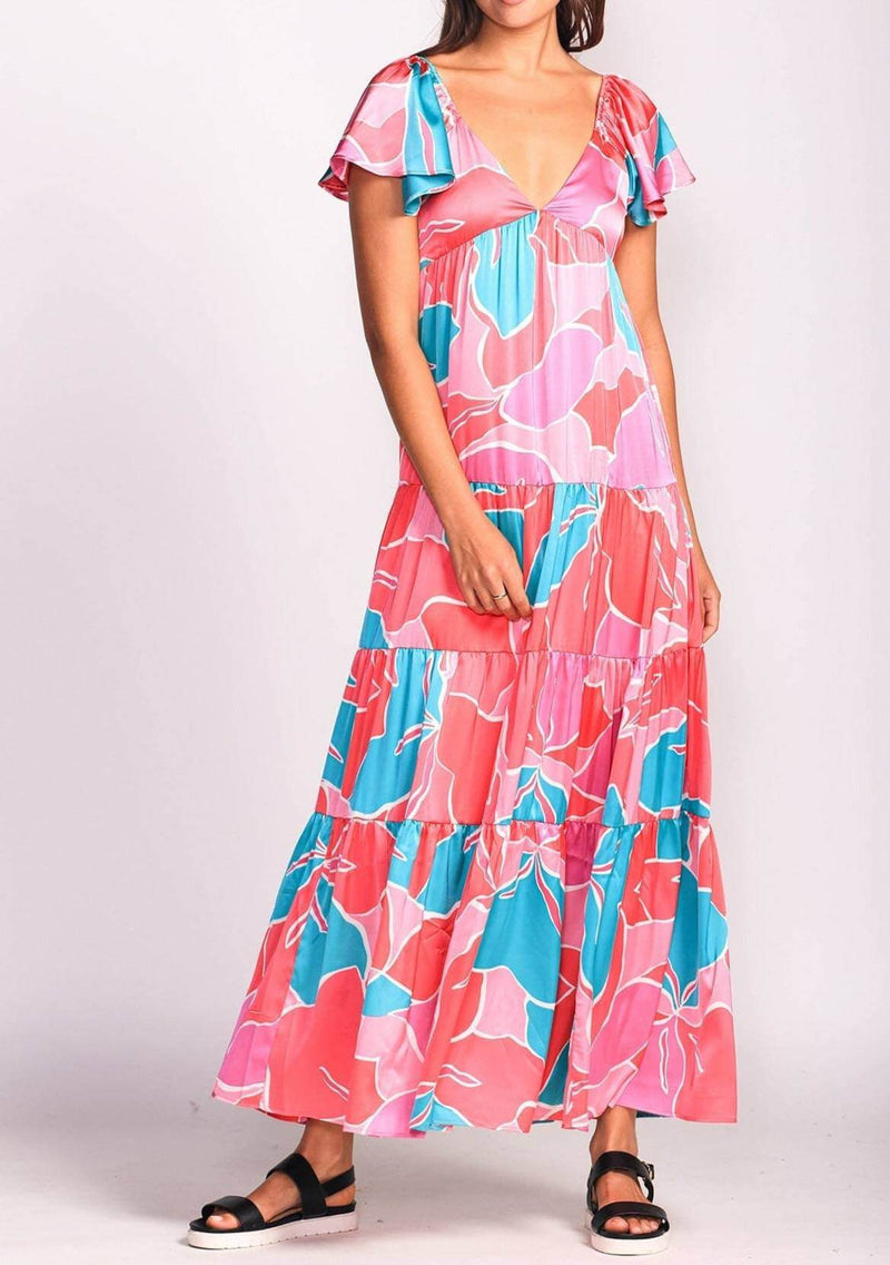Model wearing the Jessica Dress by Pink Martini, front view showing deep V neckline and tiered skirt