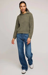 Full-length view, Gentle Fawn Jessica sweater in moss green paired with jeans and sneakers – Aurora