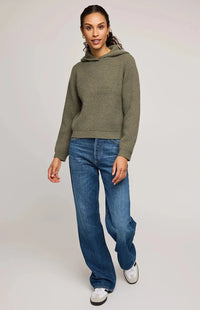 Full-length view, Gentle Fawn Jessica sweater in moss green paired with jeans and sneakers – Aurora