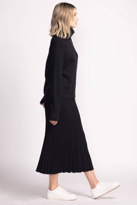 Side profile of Josie Skirt by Pink Martini in black, styled with black turtleneck sweater
