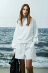 Joyela sweater by Melissa Nepton shown from the front in soft brushed knit, styled with white shorts.