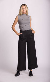 Model wearing Pink Martini Juna Pant in black, front view, paired with grey sleeveless top.