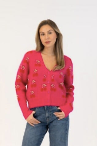 Lyla & Luxe Kailiechry cardigan in pink with red cherry design, worn with denim, available at Lemonberry