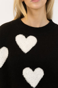 Close-up of Lyla & Luxe Ajax Sherpa Sweater soft sherpa heart detail on black knit