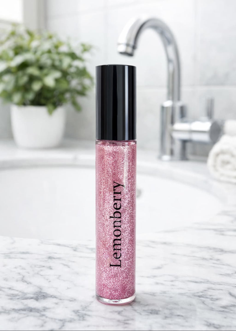 Lemonberry Signature Glitter Lip Gloss in Pink Rocks styled on a bathroom counter, Lemonberry Aurora