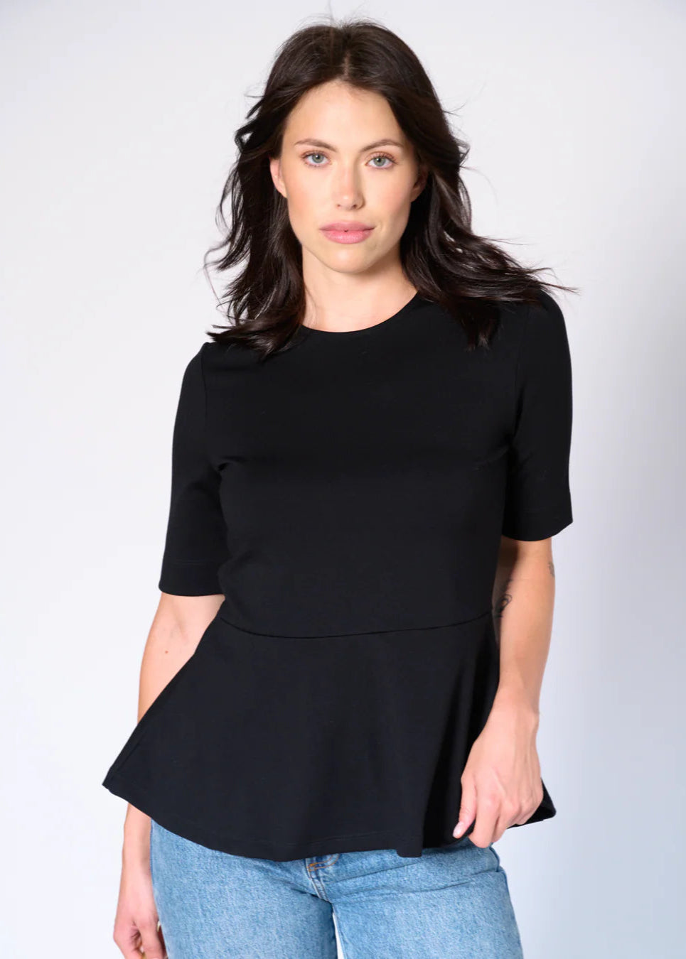 Front view of Lisa Peplum Top by Preloved in black, styled with jeans at Lemonberry Aurora
