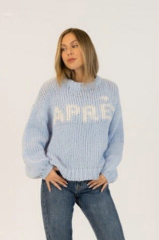 Model wearing Lyla + Luxe Lorelai light blue après-ski pullover with bold text, styled with jeans