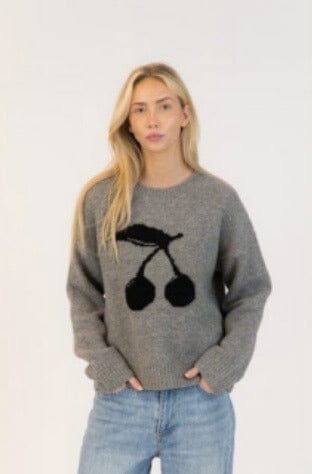 Model wearing Lyla + Luxe LOU dark grey sweater with black cherry design, styled with jeans
