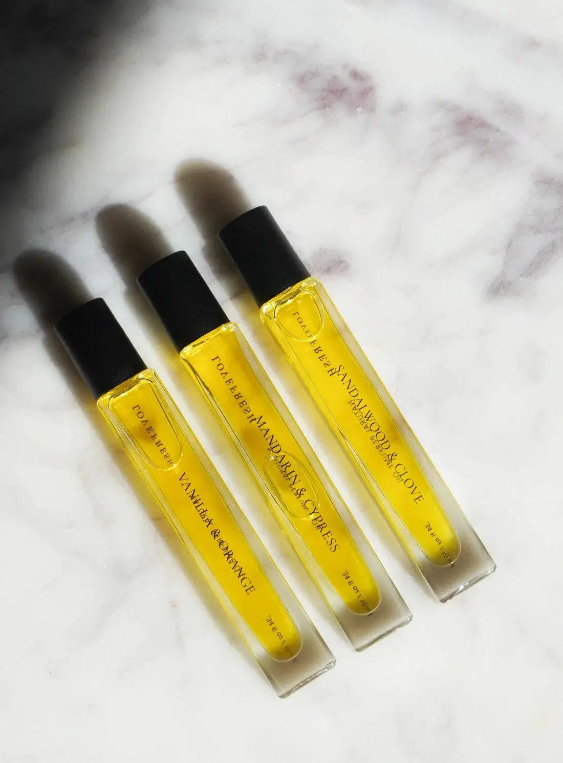 Flat lay of Lovefresh perfume oils in Vanilla & Orange and Mandarin & Cypress — clean Canadian scents available at Lemonberry in Aurora, ON