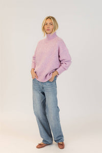 Lyla & Luxe Aggie pink mix sweater styled with hands in pockets for a cozy look