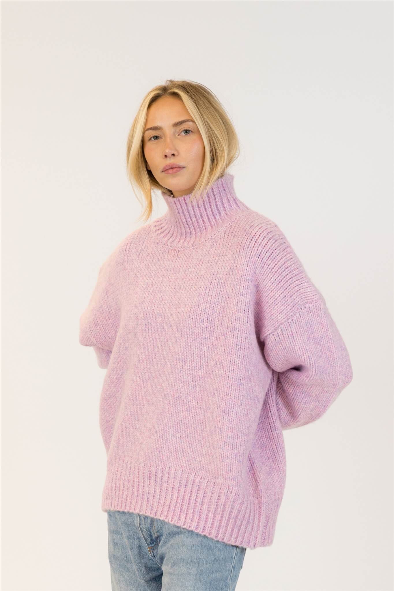 Lyla & Luxe Aggie pink mix sweater tucked into jeans for casual styling