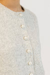Close-up of pearl details on Aisha Pearl sweater in grey marl