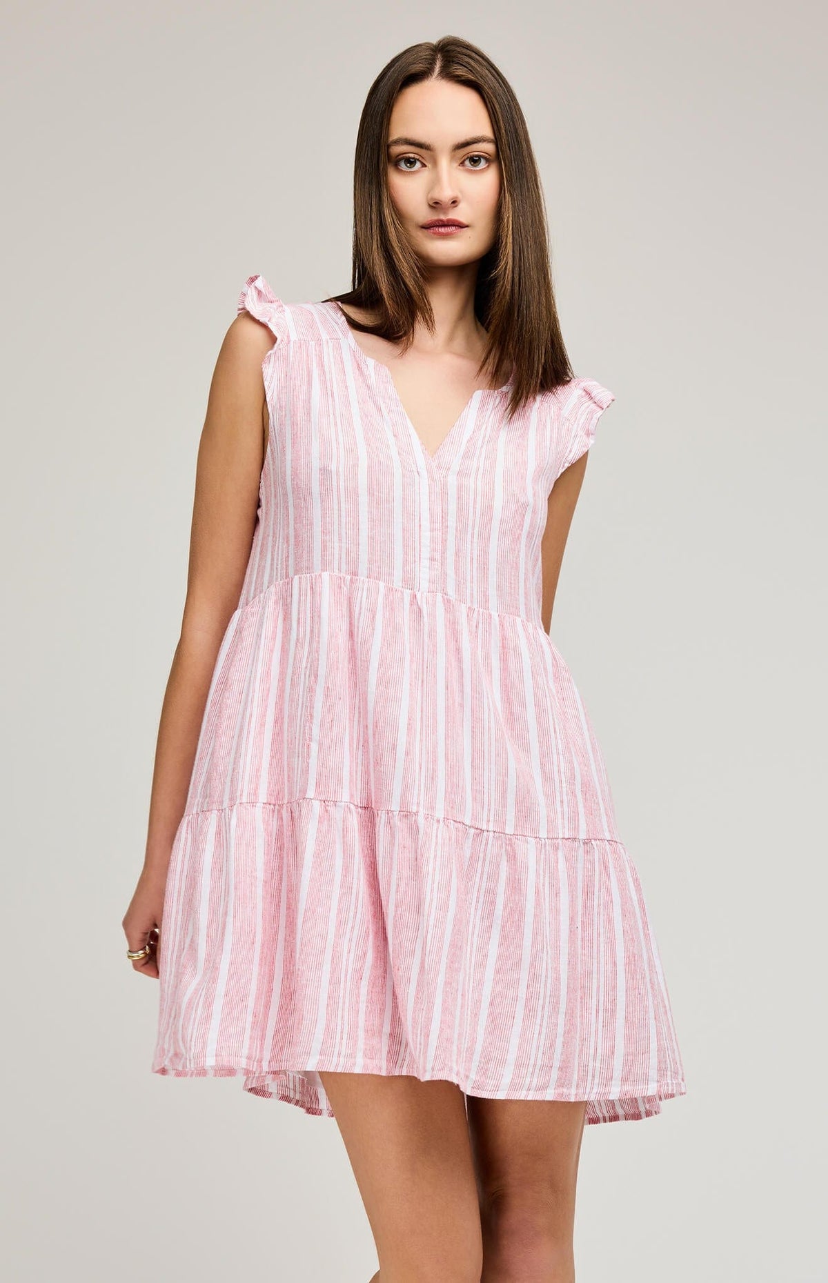 A model wearing the Maggie Mini dress by Gentle Fawn in red and white stripe.