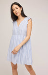 Model posing with a little sway, in the blue and white Maggie mini dress by Gentle Fawn.