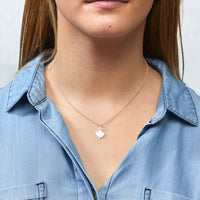 Silver Maple Leaf Charm Necklace by Foxy Originals, styled on model in light denim shirt