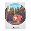 Maple Leaf Charm Necklace in gold displayed on card with cabin forest background – Foxy Originals Canadian jewelry