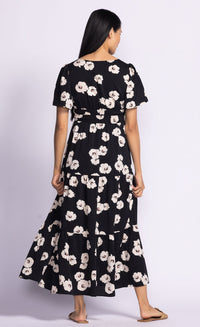 Model wearing the Margaret Dress by Pink Martini, paired with brown slides, available at Lemonberry nearby Newmarket and Richmond Hill.