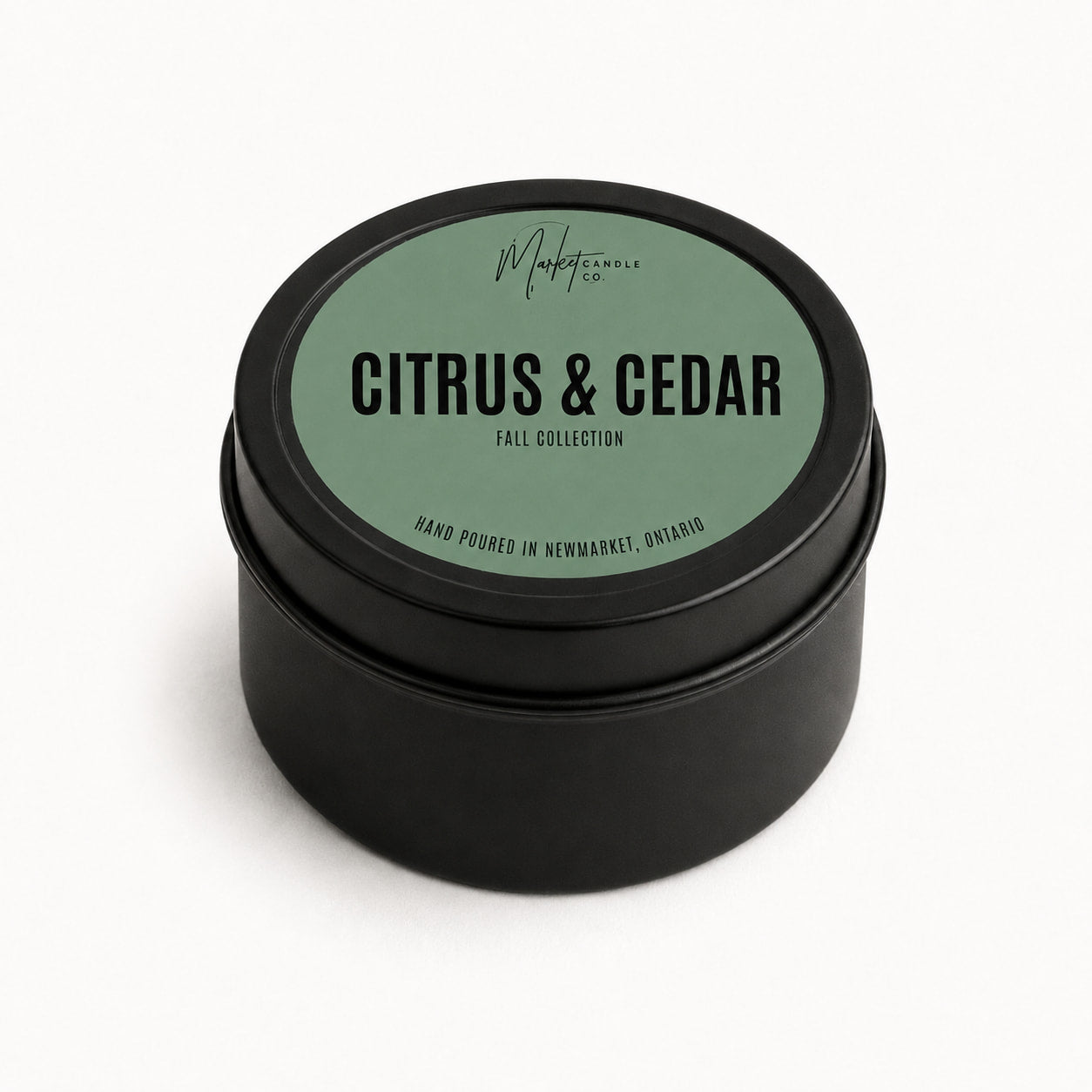 Market Candle Company Citrus and Cedar mini soy candle in a black tin with a sage green label
