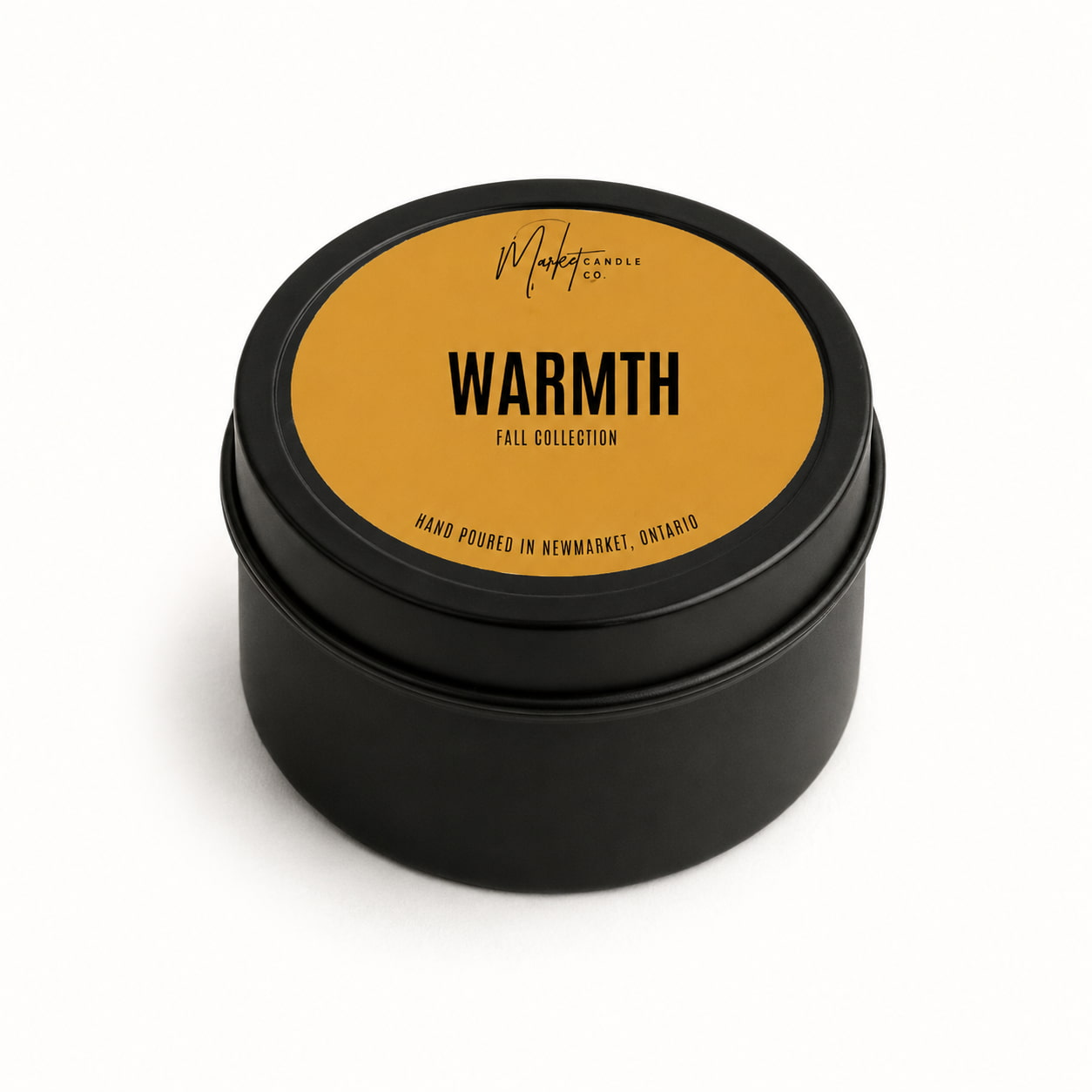 Market Candle Company Warmth mini soy candle in a black tin with a gold label
