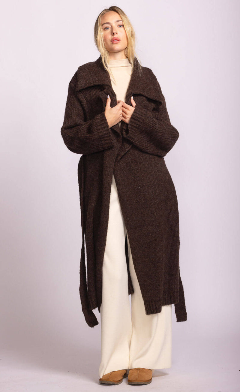 Model wearing Martha Sweater in dark brown by Pink Martini, long belted cardigan, styled over cream turtleneck